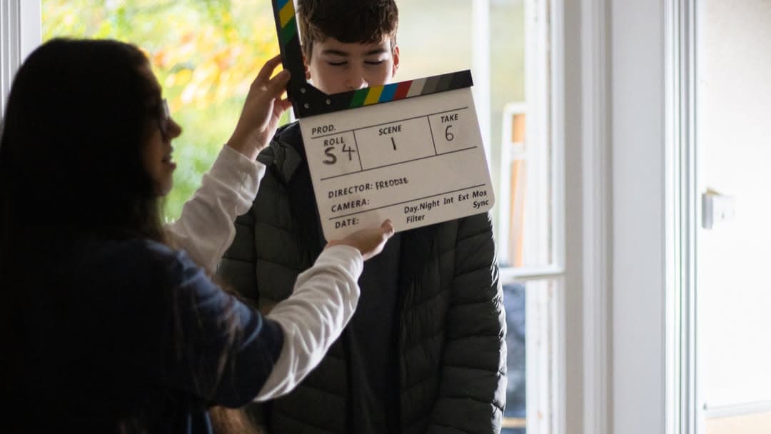 Students collaborating on film project